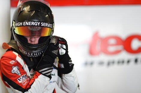 Calan Williams putting his helmet onto race