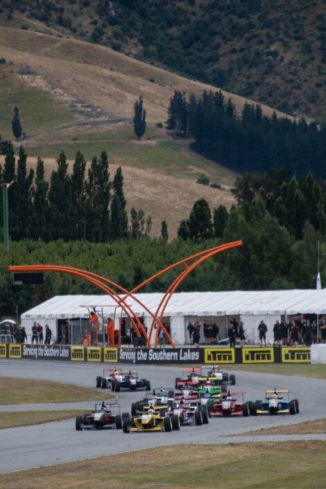 Formula 3 cars approaching the finish line